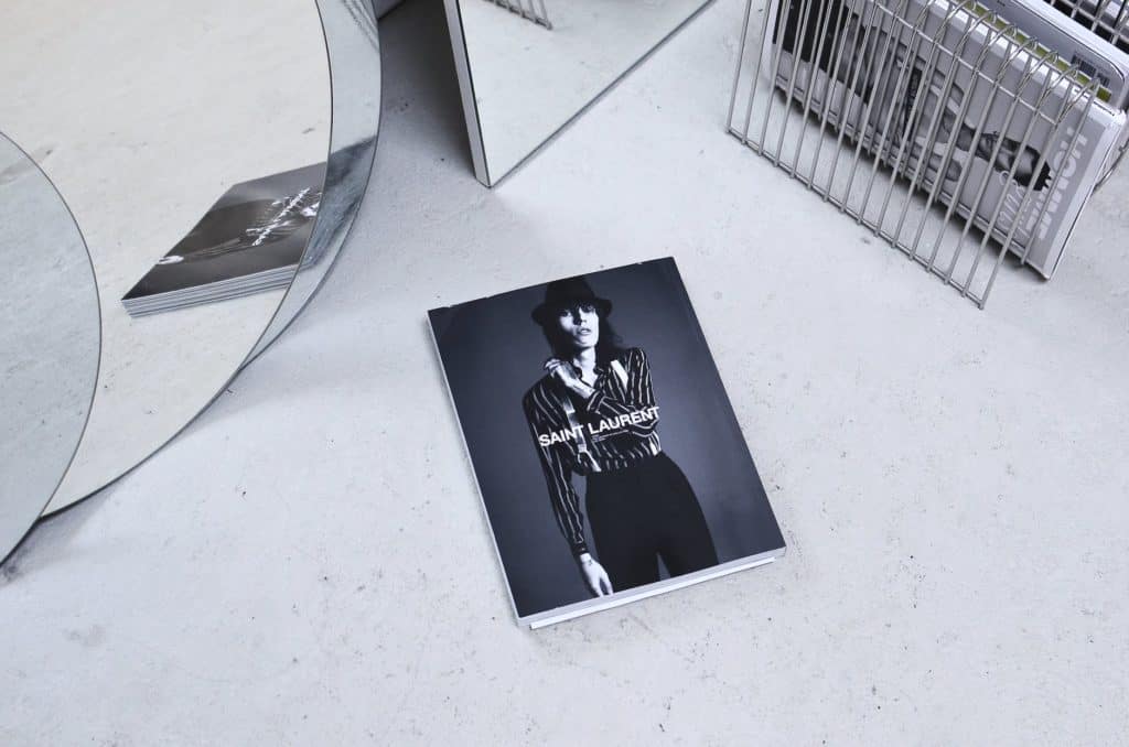 fashion magazine on table near creative mirrors